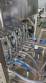 Complete filling line with Tecman Nelpas Tecnoenvase Tudela bottle filling, labeling, capping, and positioning machines for cosmetic liquids.