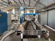 Automatic baling machine with shrink tunnel for bottles and jars in bales.