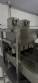 Automatic stainless steel deep fryer for donuts and cream puffs.