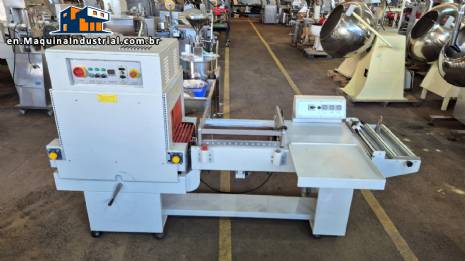 L-shaped packaging sealer with semi-automatic shrink tunnel.