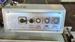 L-shaped packaging sealer with semi-automatic shrink tunnel.