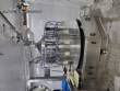 Filling line for 10 and 20 liter gallon jugs with filling machine and rinser/washer.