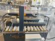 Adhesive tape case sealer with safety enclosure and door sensors Strapack