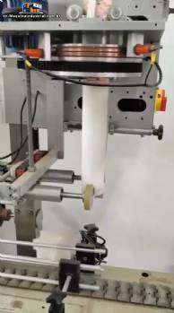 Label applicator machine with steam-operated shrink tunnel for sleeves.