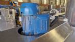 Labeling machine with steam sleeve tunnel and bottle baler
