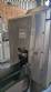 Labeling machine with steam sleeve tunnel and bottle baler