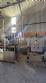 Labeling machine with steam sleeve tunnel and bottle baler