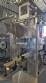 Labeling machine with steam sleeve tunnel and bottle baler