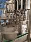 Zegla rotary filling machine with rinser and three-block capping system.