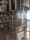 Zegla rotary filling machine with rinser and three-block capping system.